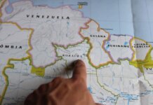 Discover Roraima, Brazil with a finger pointing on a detailed map.
