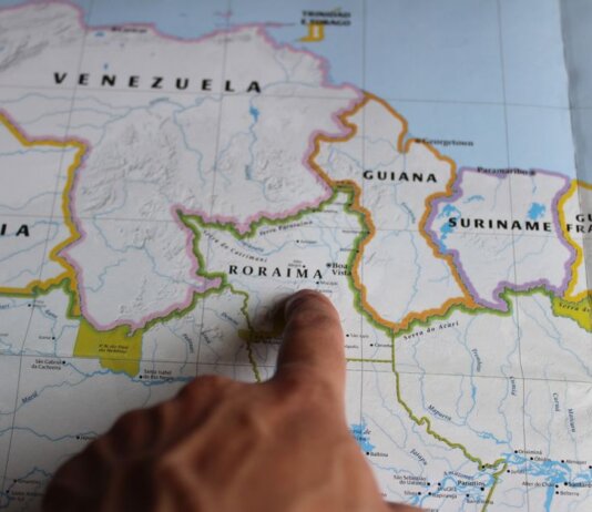 Discover Roraima, Brazil with a finger pointing on a detailed map.