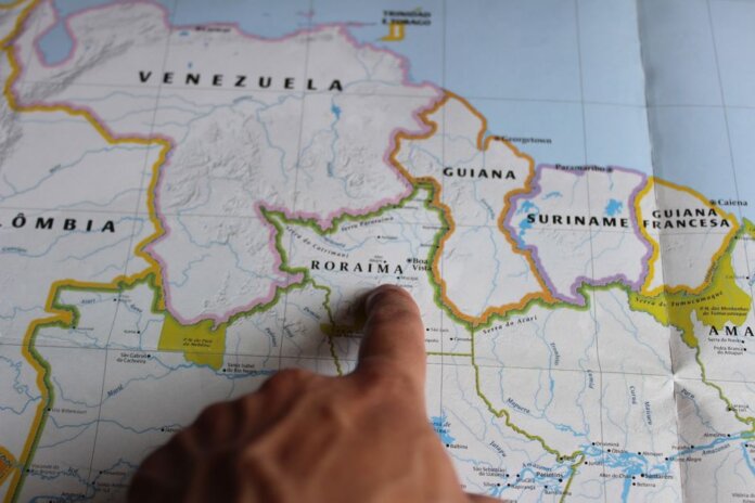 Discover Roraima, Brazil with a finger pointing on a detailed map. Discover Roraima, Brazil with a finger pointing on a detailed map.