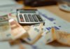Учёные Западного университета получили $16,3 млн на медицинские исследования Euro banknotes and calculator on financial documents, focusing on business budget planning.