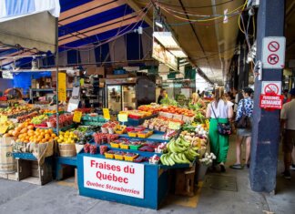 Explore a bustling street market in Quebec City showcasing fresh fruits and vegetables.