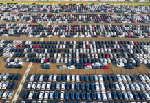 From above of rows with many contemporary different expensive automobiles on asphalt in daytime