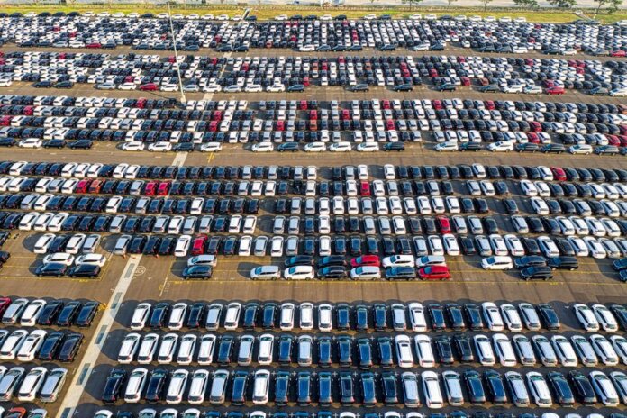 From above of rows with many contemporary different expensive automobiles on asphalt in daytime From above of rows with many contemporary different expensive automobiles on asphalt in daytime