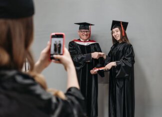 Graduates celebrating achievement in cap and gown, capturing memories.
