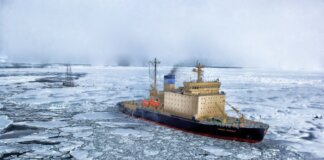 Крупнейший канадский ледокол достиг Северного полюса Icebreaker ship cutting through vast frozen ocean, showcasing winter exploration.