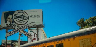Iconic Los Angeles Carney's restaurant featuring train car dining and bold signage.