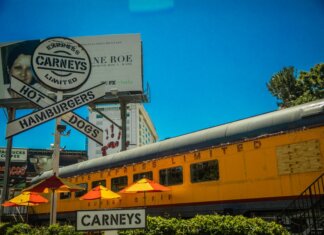 Iconic Los Angeles Carney's restaurant featuring train car dining and bold signage.