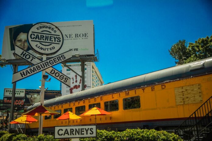 Iconic Los Angeles Carney's restaurant featuring train car dining and bold signage. Iconic Los Angeles Carney's restaurant featuring train car dining and bold signage.