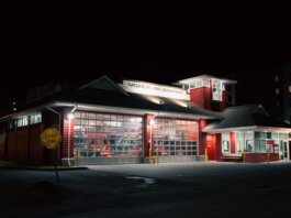 Illuminated Gatlinburg Fire Department building at night with a dead-end sign visible.