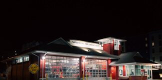 Illuminated Gatlinburg Fire Department building at night with a dead-end sign visible.