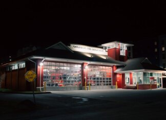 Illuminated Gatlinburg Fire Department building at night with a dead-end sign visible.