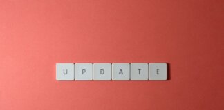 Keyboard keys arranged to spell 'update' on a vibrant red background, ideal for conveying tech concepts.