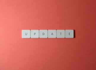 Keyboard keys arranged to spell 'update' on a vibrant red background, ideal for conveying tech concepts.