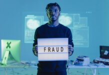 Масштабная реформа Уголовного кодекса Канады вступила в силу Man holding a 'FRAUD' sign in a tech setting, symbolizing cybersecurity threats.