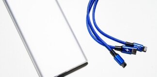 Minimalist image of a power bank with blue USB charging cables on a white background.