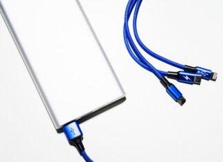Minimalist image of a power bank with blue USB charging cables on a white background.