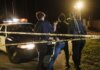 В Лондоне при задержании угнанного авто изъяли обрезы и наркотики Nighttime arrest scene with police officers and patrol car behind caution tape.