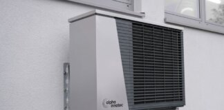 Outdoor air conditioning unit mounted on a residential building exterior.