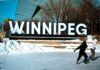 People ice skating in front of the iconic Winnipeg sign on a sunny winter day.