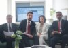 Professional team in corporate attire ready for a meeting, engaged in discussion.