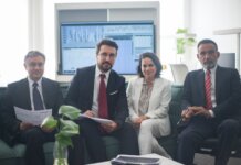 Professional team in corporate attire ready for a meeting, engaged in discussion.