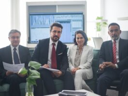 Professional team in corporate attire ready for a meeting, engaged in discussion.