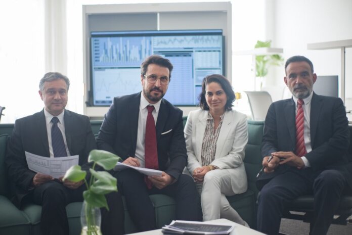 Professional team in corporate attire ready for a meeting, engaged in discussion. Professional team in corporate attire ready for a meeting, engaged in discussion.