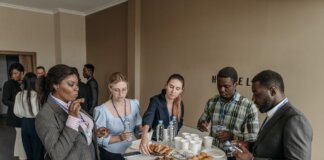 Prominent business professionals networking and enjoying refreshments at a conference.
