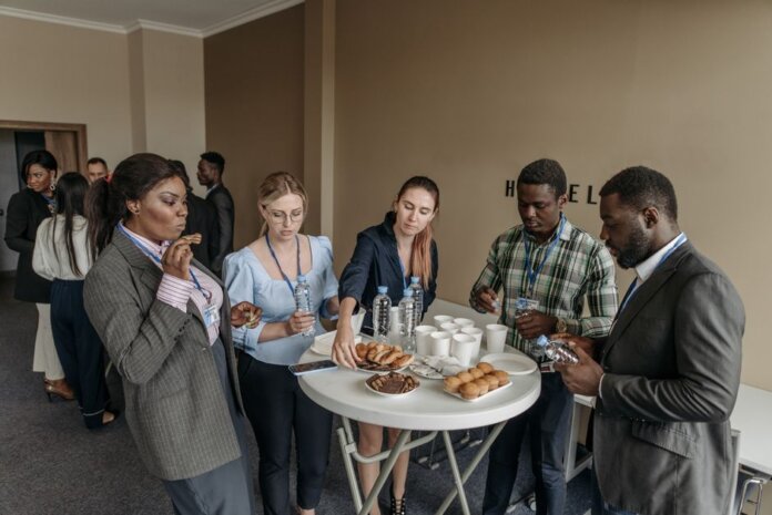 Prominent business professionals networking and enjoying refreshments at a conference. Prominent business professionals networking and enjoying refreshments at a conference.
