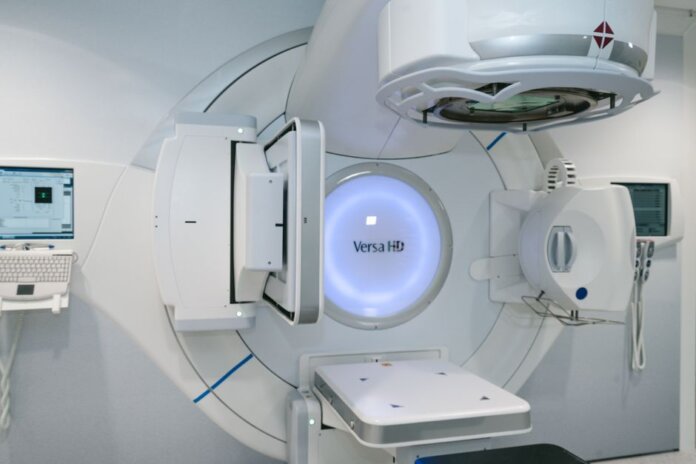 State-of-the-art radiation therapy machine used for cancer treatment in a medical facility. State-of-the-art radiation therapy machine used for cancer treatment in a medical facility.