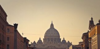 Street view of Saint Peter's Basilica in Vatican City during dusk, capturing the iconic architecture and Roman skyline.
