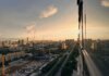 Stunning aerial sunset view of Xi'an cityscape featuring construction and urban expansion.