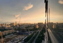 Stunning aerial sunset view of Xi'an cityscape featuring construction and urban expansion.