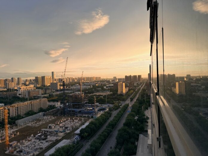 Stunning aerial sunset view of Xi'an cityscape featuring construction and urban expansion.