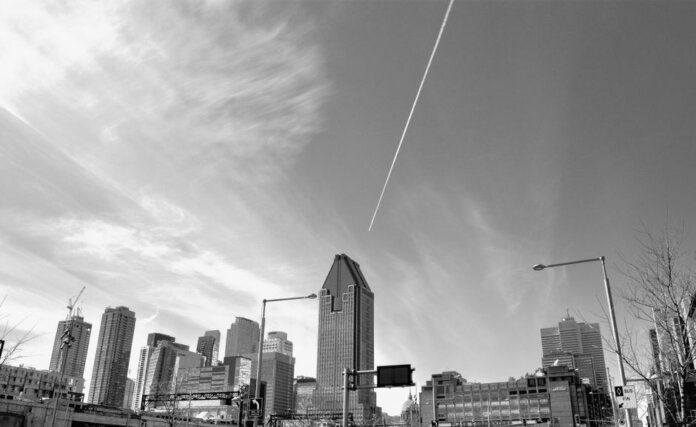 Stunning black and white view of Montreal's skyline featuring tall skyscrapers and dynamic clouds. Stunning black and white view of Montreal's skyline featuring tall skyscrapers and dynamic clouds.