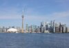 Stunning view of the Toronto skyline featuring the iconic CN Tower by Lake Ontario.