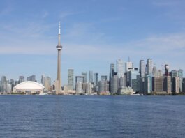 Stunning view of the Toronto skyline featuring the iconic CN Tower by Lake Ontario.