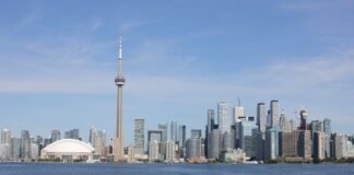 Stunning view of the Toronto skyline featuring the iconic CN Tower by Lake Ontario.