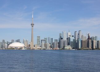 Stunning view of the Toronto skyline featuring the iconic CN Tower by Lake Ontario.