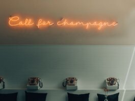 Stylish interior featuring retro telephones and a neon 'Call for Champagne' sign.