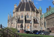 The historic Parliamentary Library, part of Canada’s Parliament buildings in Ottawa, under clear blue skies.
