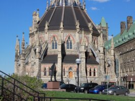 The historic Parliamentary Library, part of Canada’s Parliament buildings in Ottawa, under clear blue skies.