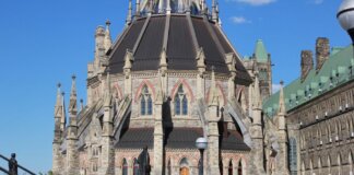 The historic Parliamentary Library, part of Canada’s Parliament buildings in Ottawa, under clear blue skies.