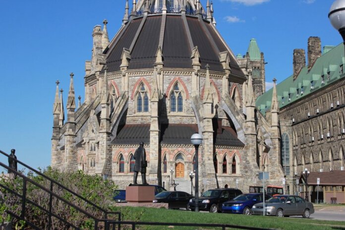 The historic Parliamentary Library, part of Canada’s Parliament buildings in Ottawa, under clear blue skies.