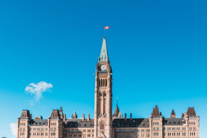 The Peace Tower of Canada's Parliament in bright daylight against a blue sky. The Peace Tower of Canada's Parliament in bright daylight against a blue sky.