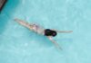 Саммер Макинтош завоевала золото на 400 м комплексом на Pan Pacific Top view of anonymous slim lady floating underwater in crystal clear blue water in swimming pool on resort