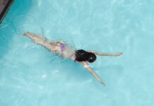 Саммер Макинтош завоевала золото на 400 м комплексом на Pan Pacific Top view of anonymous slim lady floating underwater in crystal clear blue water in swimming pool on resort