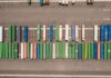 Top view of neatly arranged cargo containers in a shipping port, highlighting logistics and global trade.