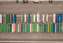 Top view of neatly arranged cargo containers in a shipping port, highlighting logistics and global trade.
