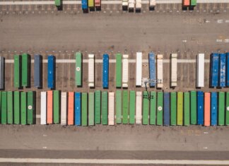 Top view of neatly arranged cargo containers in a shipping port, highlighting logistics and global trade.